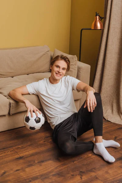 Happy man holding football at home, end of quarantine concept — Stock Photo