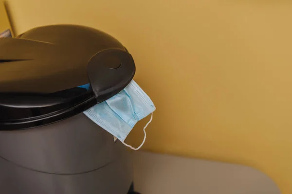 Safety medical mask in trash can, end of quarantine concept — Stock Photo