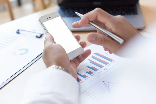 Men use phones in their offices, young men and businessmen use their smartphones to search for financial information to learn more, use phones to study and learn.