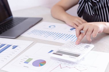 Şirket finans ve yatırım kavramları, sunumların planlanması, finans kavramının hazırlanması için şirket gelirlerini ve harcamalarını analiz etmek için hesap makineleri ve veri grafikleri kullanan insanlar