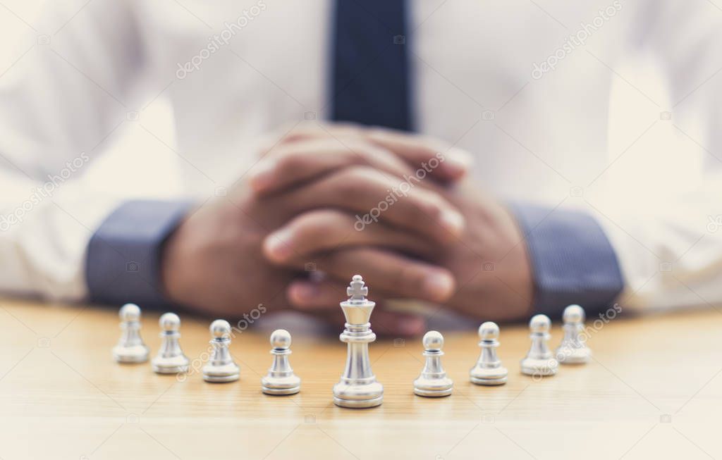 Business men make plans to play chess with Prudence and success, Management or leadership concept.