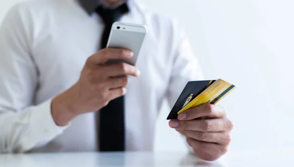 Businessman use mobile phones to register for security Online with a credit card to buy products online through application,Online shopping or Internet technology concept.