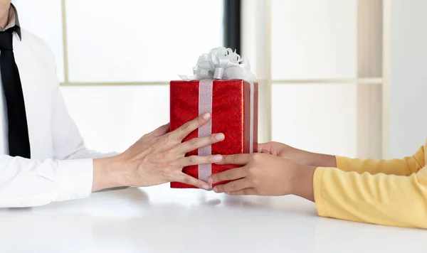 Young men hold gift boxes to give to young women, Give gifts to your loved ones on this important holiday season ,New Year\'s Day, Chrismas Day, Give a gift concept.