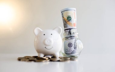 Domuz kumbarası dolup taşıyordu ve dolar banknotları dahil, tasarruf, muhasebe ve finans konsepti.