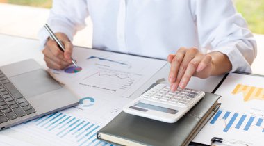 Muhasebe işadamları gelir-gider hesapları yapıyor ve emlak yatırım verileri, mali ve vergi sistemleri kavramını analiz ediyorlar.
