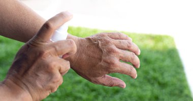 Adam bakteri ve virüslerden kurtulmak için alkol spreyi kullanıyor, Covid-19 virüs enfeksiyonunu önlemek için yüzde 70 alkol kullanıyor, virüs konseptini koruyor..