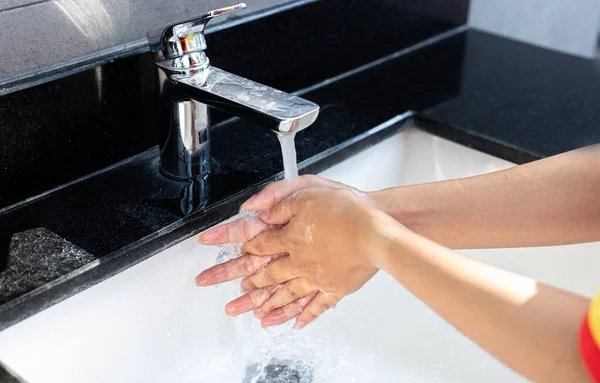 Man is washing his hands in a sink sanitizing the colona virus for sanitation and reducing the spread of COVID-19 spreading throughout the world, Hygiene ,Sanitation concept.