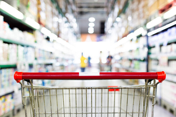 Shopping cart in supermarket, Abstract blurred photo in shopping malls, Cart in the market concept.