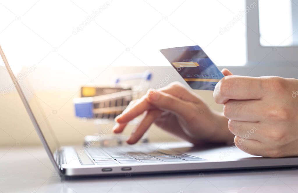 women use laptop to register online purchases using credit card payments, Convenience in the world of technology and the internet, Shopping online and banking online concept.
