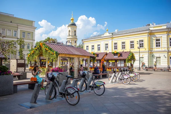 People sitting near bicycle rental station on Pyatnitskaya stree — Stock Photo, Image