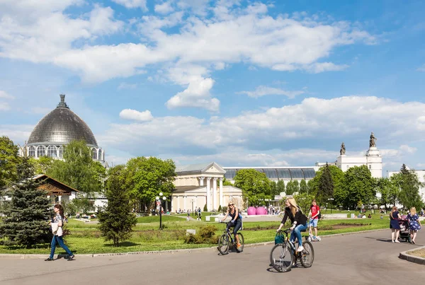 Young people walking and cycling at VDNKh park complex in Moscow — Stock Photo, Image
