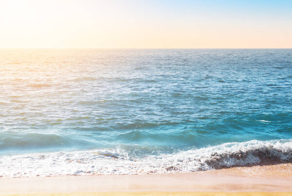 Seafoam on the coast with water surface on the background
