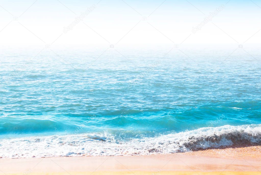Seafoam on the coast with water surface on the background