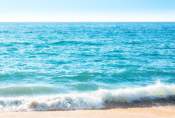 Seafoam on the coast with water surface on the background
