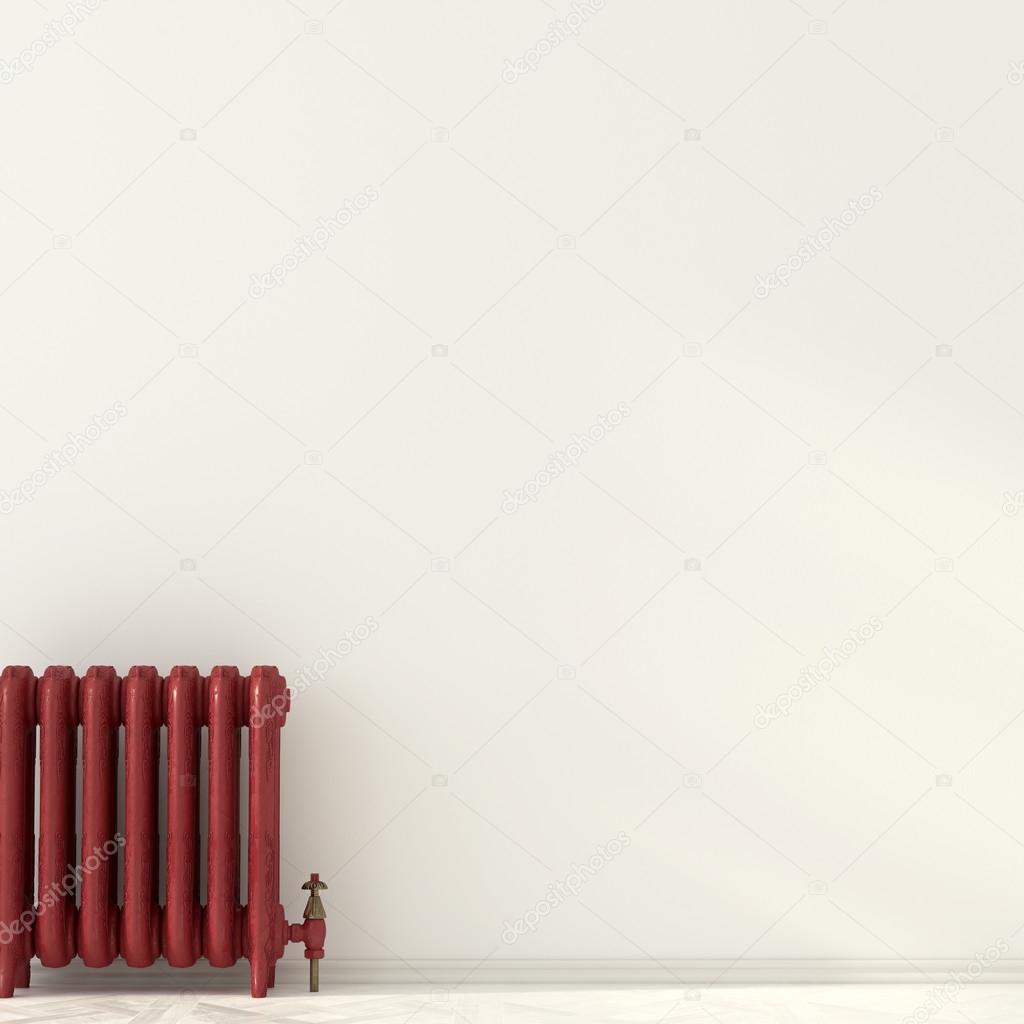 Red radiator near a white wall 