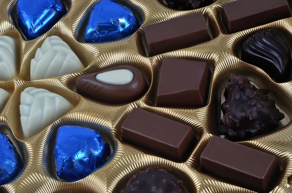 Assortment of chocolates in a box close up on a white background