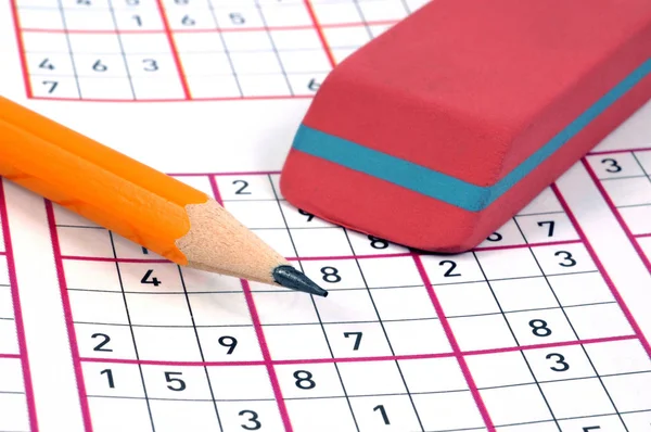 Sudoku grids with eraser and pencil in close up 
