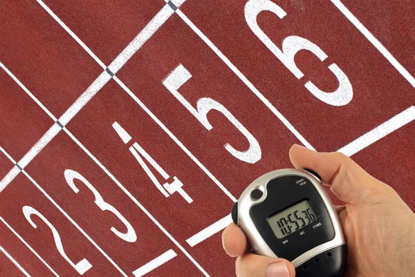 Cronómetro Mano Con Una Pista Atletismo Fondo — Foto de Stock