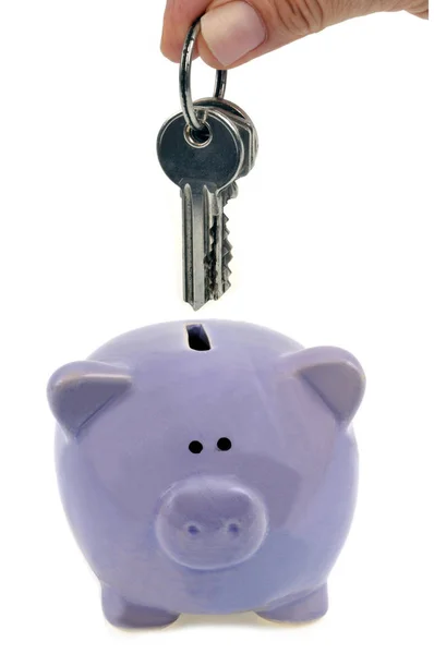Someone Putting Bunch Keys Piggy Bank Close White Background — Stock Photo, Image