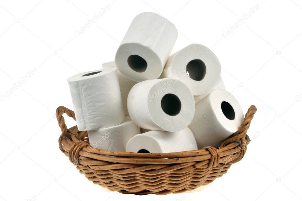 Rolls of loose toilet paper in a wicker basket close up on white background 