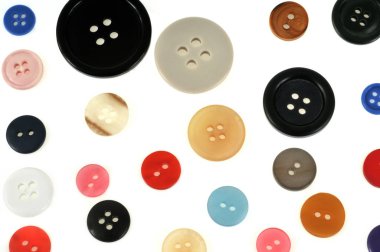 Plastic buttons of different colors and sizes on a white background