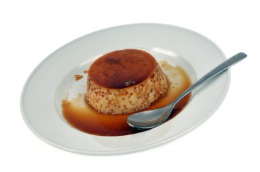 Egg custard served on a plate close-up on white background