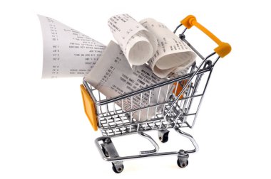 Cash receipts in a supermarket shopping cart close up on white background 