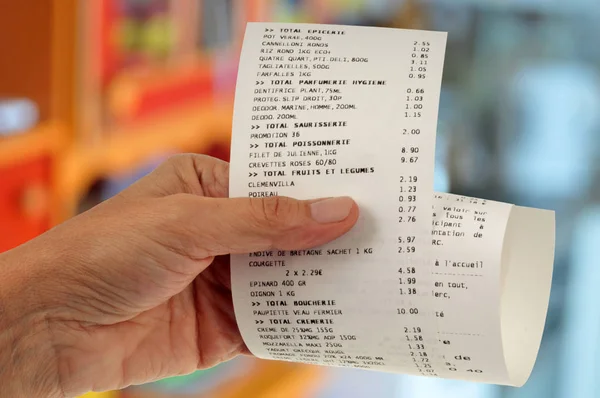 Cash receipt in hand close up