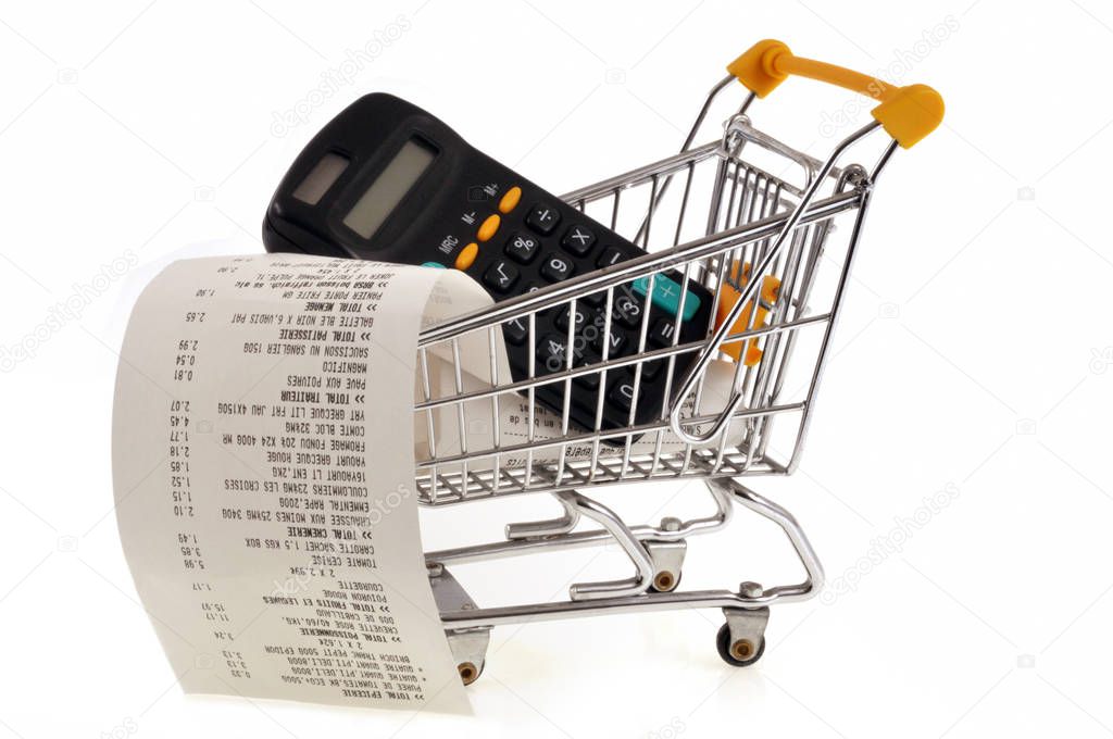 Cash receipt with calculator in a supermarket shopping cart close up on white background