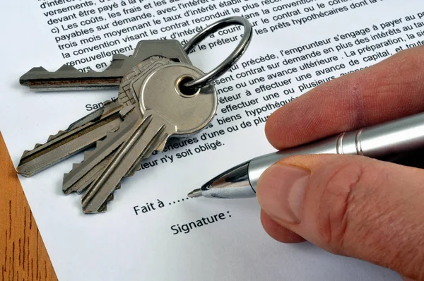 Signing a rental contract with a pen close-up