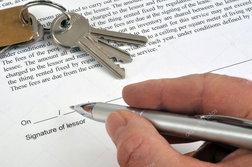 Lessor signing a rental contract in English with a pen close-up