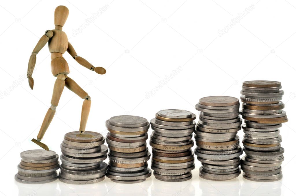 Economic development concept with a wooden mannequin climbing a staircase made of coins