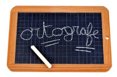 Spelling written with mistakes on a school slate with chalk