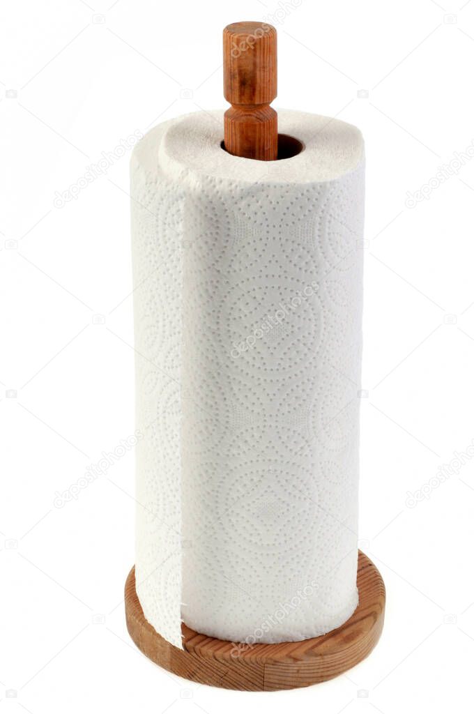 Paper towel roll on wooden dispenser close up on white background 