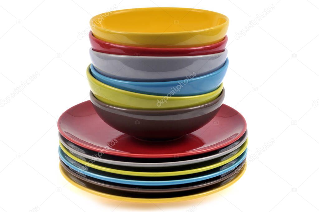 Plates of different colors stacked on white background 