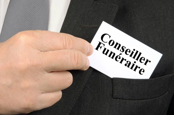 Closeup of funeral adviser business card in jacket pocket
