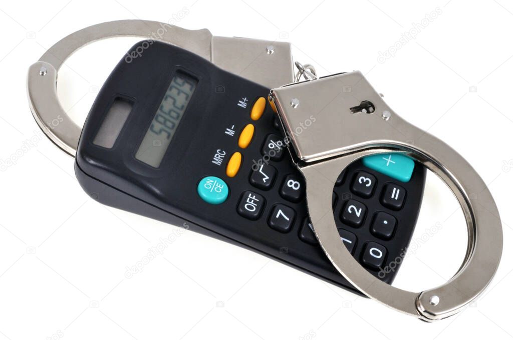 Tax fraud concept with handcuffs on a bank calculator close up on white background