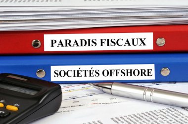 Tax havens and offshore companies stacked on a desk  clipart
