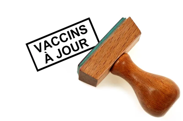 白い背景に最新のワクチンを示すラバースタンプ — ストック写真