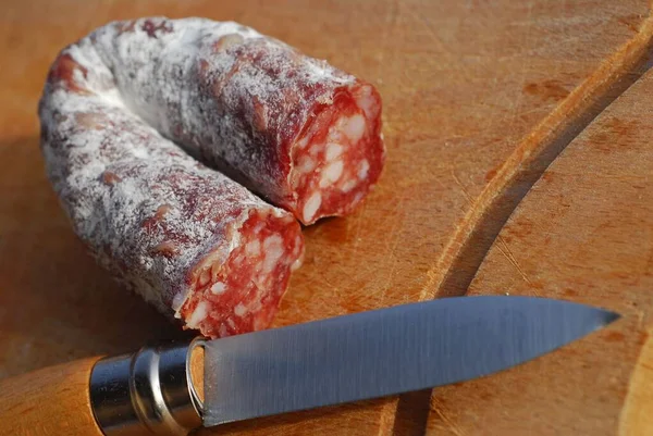 Dry sausage cut with a knife close-up — Stock Image Dry Sausage Cut Knife Close Royalty Free Stock Photos