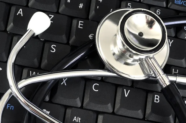 Online medicine concept with a stethoscope on a computer keyboard