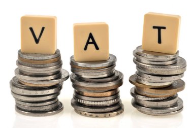 VAT concept with stacks of coins on white background clipart