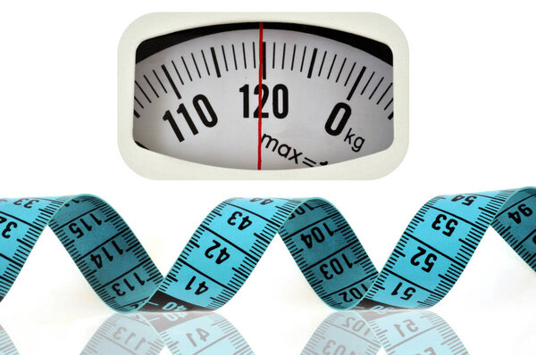 Overweight concept with a bathroom scale and a seamstress meter