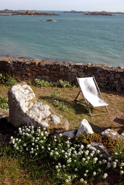 Small garden with a deck chair on the island of Chausey in Normandy