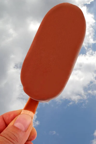 Iced Stick Coated Chocolate Close Cloudy Sky Background — Stock Photo, Image