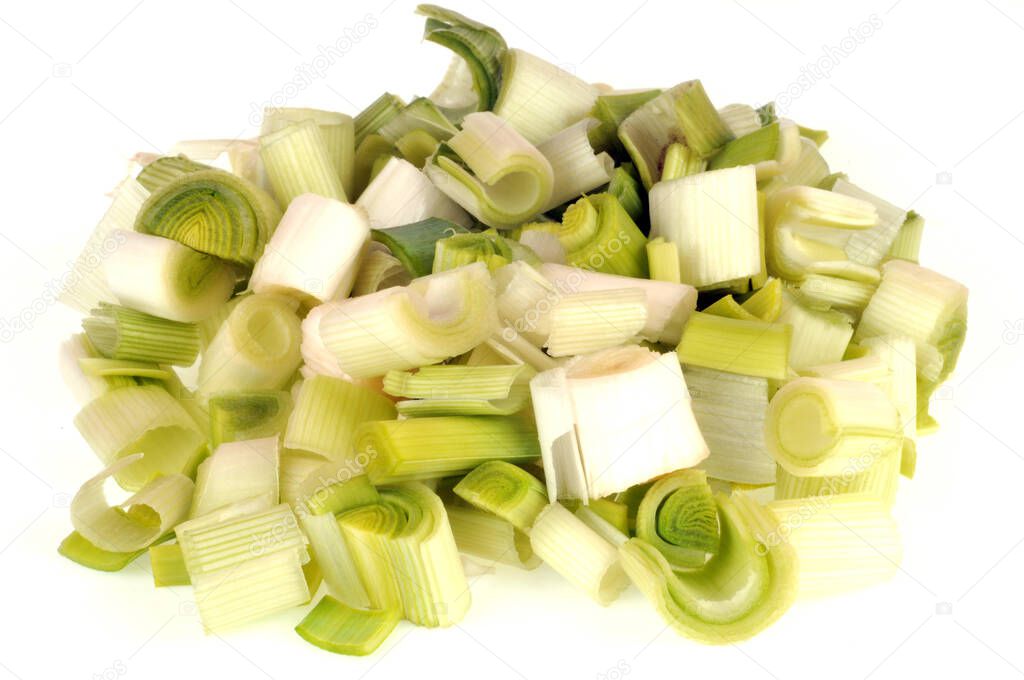 Raw leeks cut into pieces close up on white background 