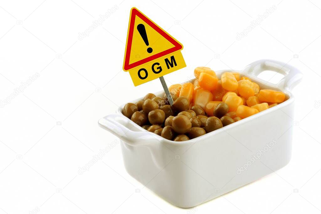 Concept of genetically modified organism with corn and peas in a ramekin with a road sign