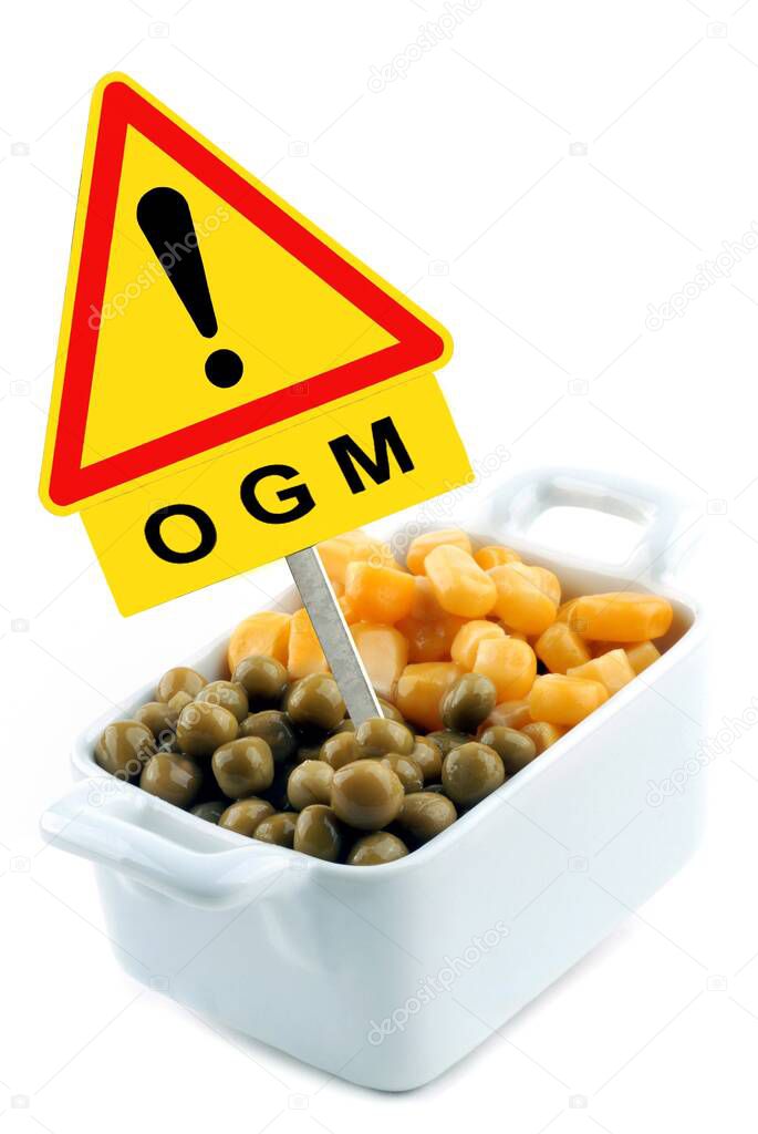 Concept of genetically modified organism with corn and peas in a ramekin with a road sign 
