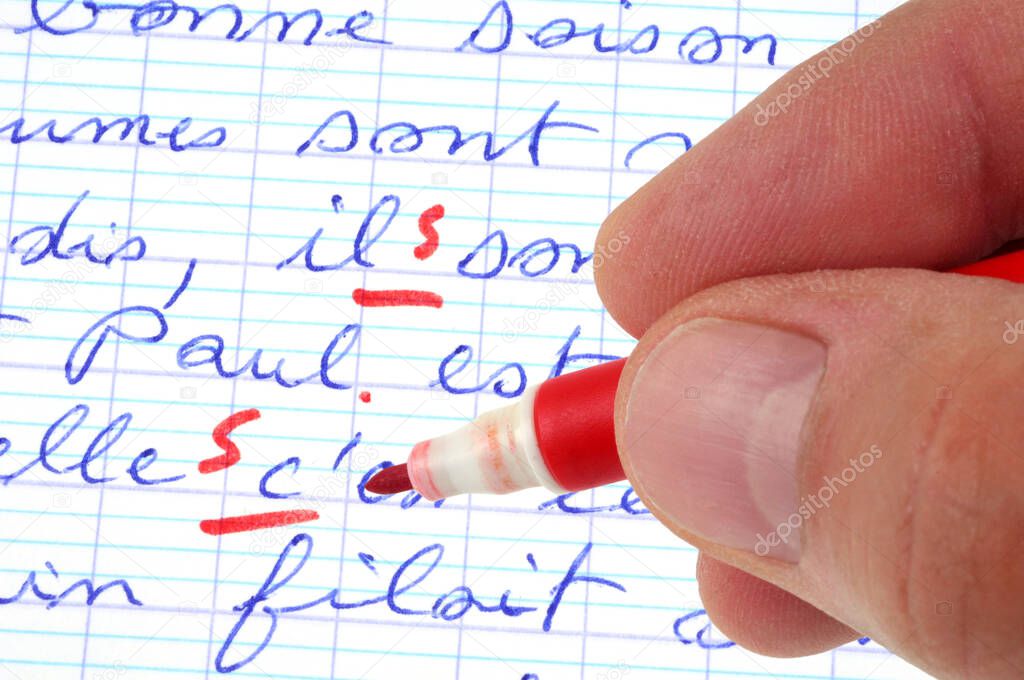 Correct dictation with red felt tip pen close up 