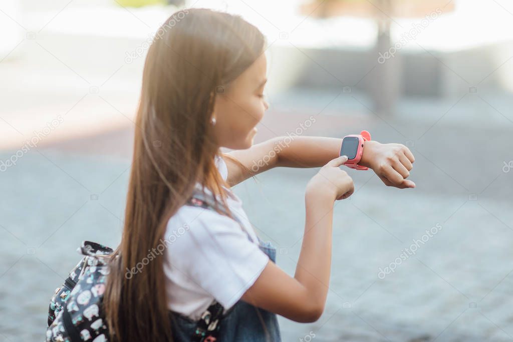 girl with smartwatch on fresh air, selective focus